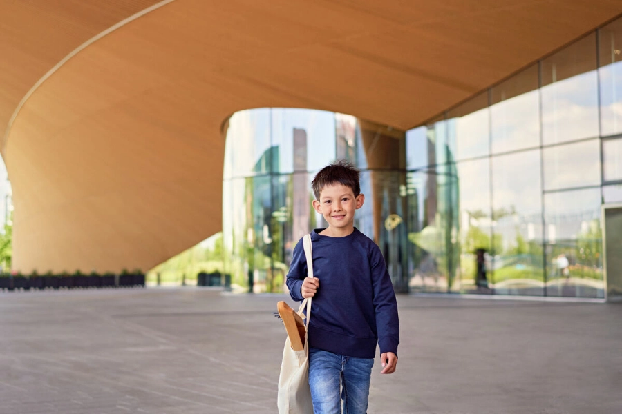 A boy holds a canvas bag of school supplies. - Mikko Törmänen / Keksi Agency A boy holds a canvas bag of school supplies. - Mikko Törmänen / Keksi Agency