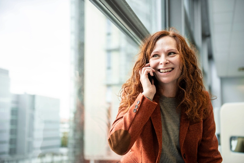 Woman on a phone call at the office Woman on a phone call at the office