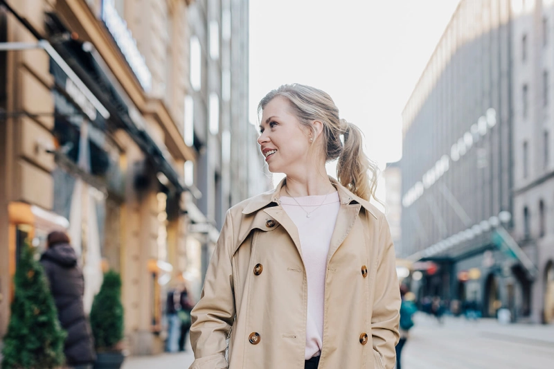 Woman walking on a downtown street. - Work in Finland / Elina Manninen Woman walking on a downtown street. - Work in Finland / Elina Manninen